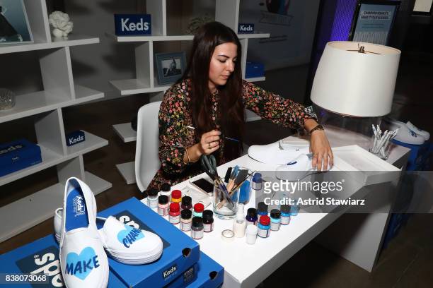 Artist paints Keds as seen during "CHAMPION EQUALITY. MAKE IT YOUR BUSINESS." panel event hosted by Keds & LOLA to celebrate Women's Equality Day at...