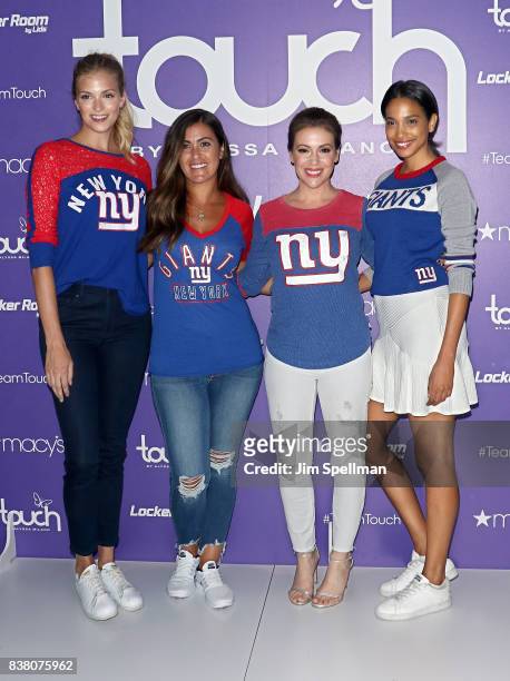 Alyssa Milano poses with models at Macy's Herald Square on August 23, 2017 in New York City.