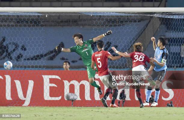 Yu Kobayashi of Kawasaki Frontale scores in the second half on a header past Urawa Reds goalkeeper Shusaku Nishikawa in the first leg of their Asian...
