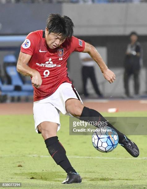 Yuki Muto of Urawa Reds scores in the second half against Kawasaki Frontale in the first leg of their Asian Champions League quarterfinal tie in...