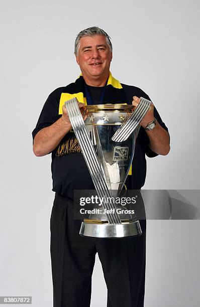 Head Coach Sigi Schmid of the Columbus Crew poses for a post-game celebration portrait with the Philip F. Anschutz trophy after defeating the New...