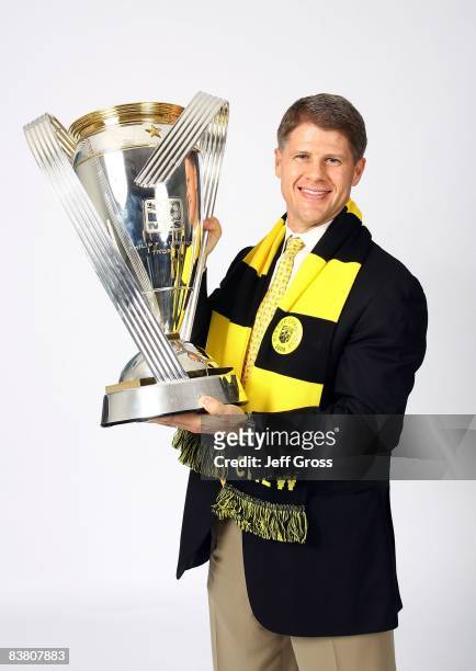 Clark Hunt of the Columbus Crew holds the Philip F. Anschutz trophy and poses for a post-game celebration portrait after the Columbus Crew defeated...
