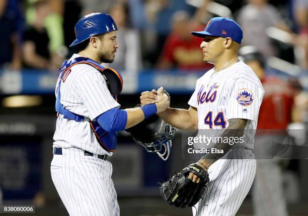 Travis d'Arnaud and AJ Ramos of the New York Mets celebrate the 4-2 win over the Arizona Diamondbacks on August 23, 2017 at Citi Field in the...