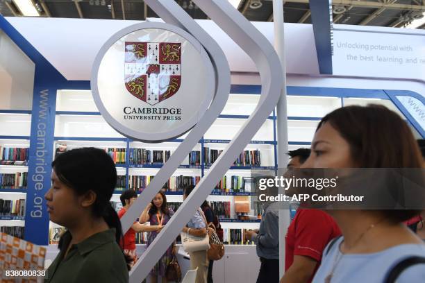 This photo taken on August 23, 2017 shows people at the Cambridge University Press stand at the Beijing International Book Fair in Beijing. Just days...
