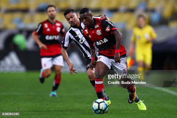 Vinicius Junior of Flamengo struggles for the ball with Rodrigo Lindoso of Botafogo during a match between Flamengo and Botafogo part of Copa do...