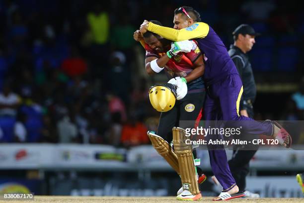 In this handout image provided by CPL T20, Sunil Narine celebrates with Darren Bravo of the Trinbago Knight Riders as Trinbago Knight Riders win...