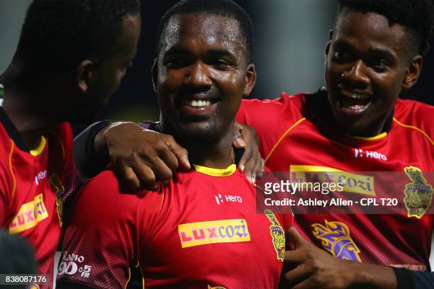 In this handout image provided by CPL T20, From left, Kevon Cooper, Darren Bravo and Ronsford Beaton of the Trinbago Knight Riders celebrate winning...