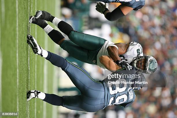 Defensive end Juqua Parker of the Philadelphia Eagles tries to shed the block of tight end John Carlson of the Seattle Seahawks during a game on...