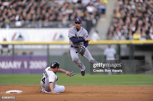 Jason Bartlett of the Tampa Bay Rays turns a double play over a sliding Paul Konerko during the game against the Chicago White Sox at U.S. Cellular...