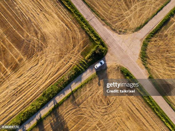 crossroad between grainfields from above, germany - crossroad stock pictures, royalty-free photos & images