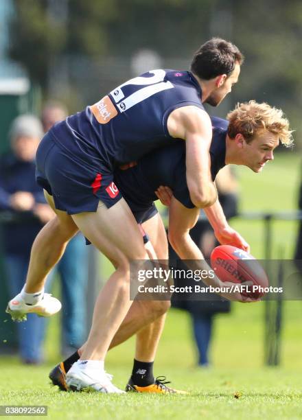 Jack Watts of the Demons is tackled by Cameron Pedersen of the Demons during a Melbourne Demons AFL training session at Gosch's Paddock on August 24,...