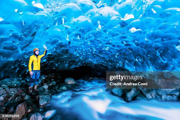 vatnajokull glacier, eastern iceland, iceland, northern europe. man standing in a crystal ice cave in winter - crystal caves ストックフォトと画像