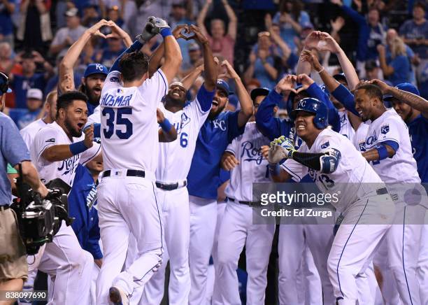 Eric Hosmer of the Kansas City Royals celebrates his game-winning three-run home run with teammates in the ninth inning against the Colorado Rockies...