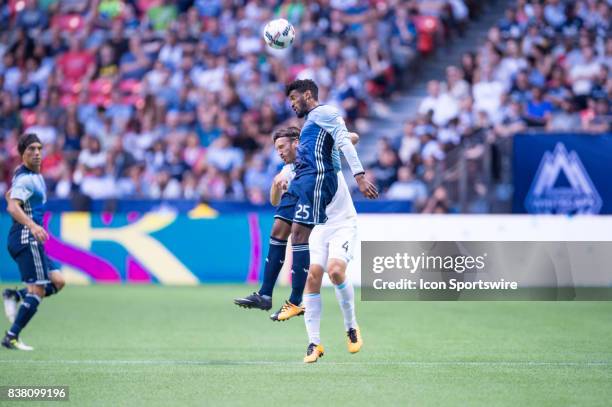 Vancouver Whitecaps midfielder Sheanon Williams and Seattle Sounders defender Gustav Svensson jump for the ball during their match at BC Place on...