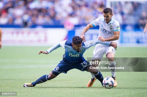 Seattle Sounders midfielder Alvaro Fernandez defends against Vancouver Whitecaps midfielder Sheanon Williams during their match at BC Place on August...