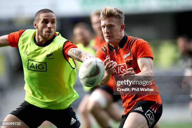 Damian McKenzie of the All Blacks passes the ball in the lineout during a New Zealand All Blacks training session at Forsyth Barr stadium on August...