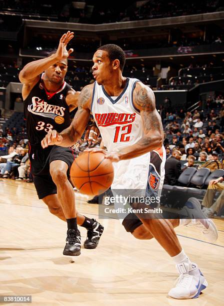 Willie Green of the Philadelphia 76ers guards against Shannon Brown of the Charlotte Bobcats on November 24, 2008 at the Time Warner Cable Arena in...