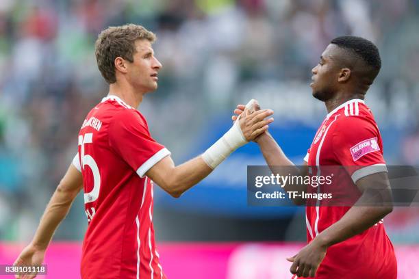 Thomas Mueller of Bayern Muenchen shakes hands with Franck Evina of Bayern Muenchen during the Telekom Cup 2017 Final between SV Werder Bremen and FC...