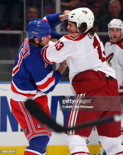 Daniel Carcillo of the Phoenix Coyotes takes a punch from Brandon Dubinsky of the New York Rangers on November 24, 2008 at Madison Square Garden in...