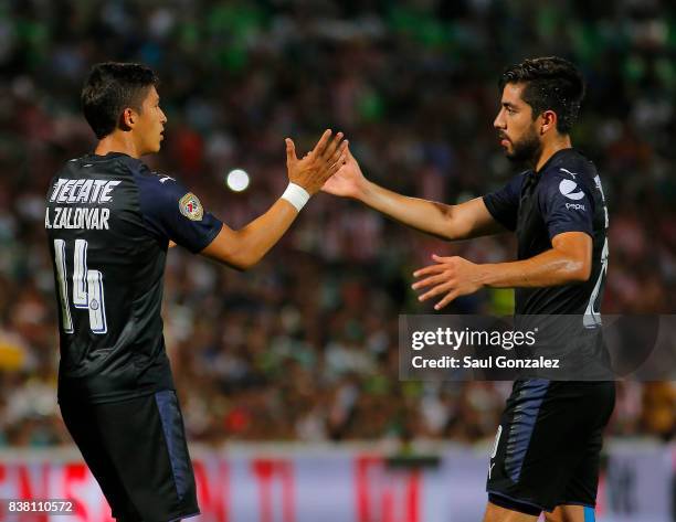 Angel Zaldivar of Chivas celebrates with teammate Rodolfo Pizarro after scoring the first goal of his team during the sixth round match between...