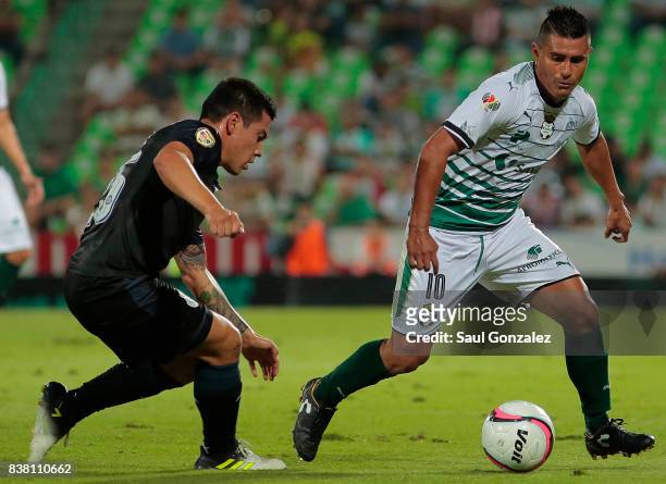 Osvaldo Martinez of Santos fights for the ball with Michael Perez of Chivas during the sixth round match between Santos Laguna and Chivas as part of...