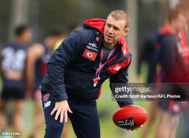 Simon Goodwin, coach of the Demons throws the ball during a Melbourne Demons AFL training session at Gosch's Paddock on August 24, 2017 in Melbourne,...