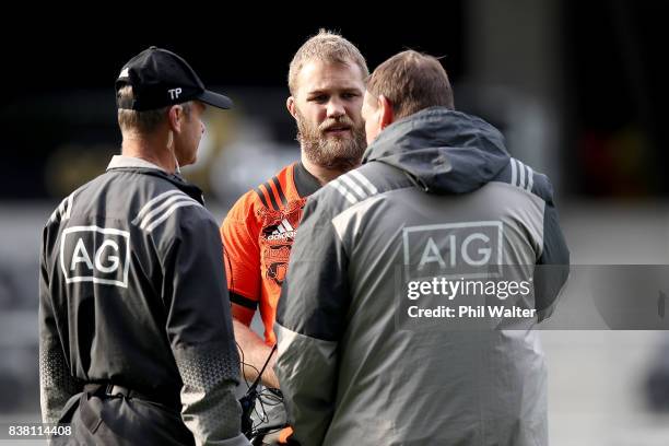 Owen Franks of the All Blacks talks with Dr Tony Page and coach Steve Hansen during a New Zealand All Blacks training session at Forsyth Barr stadium...