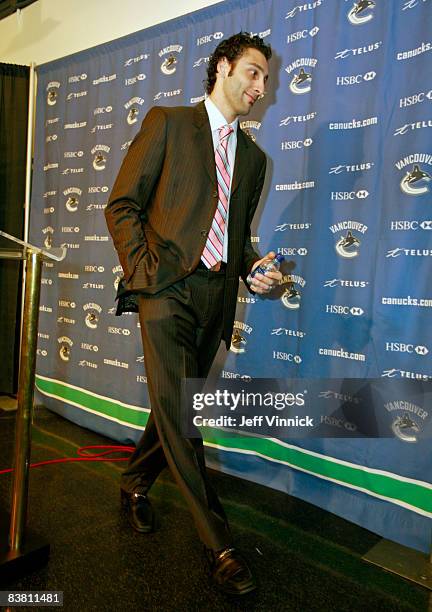 Vancouver Canucks captain Roberto Luongo exits a press conference where he addressed media questions regarding an abductor injury at General Motors...