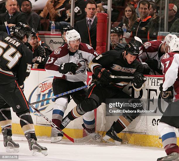 Milan Hejduk of the Colorado Avalanche collides into the boards with Nathan McIver of the Anaheim Ducks during the game on November 24, 2008 at Honda...