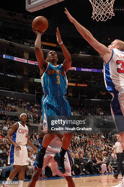 Chris Paul of the New Orleans Hornets has his shot challenged by Chris Kaman of the Los Angeles Clippers at Staples Center on November 24, 2008 in...