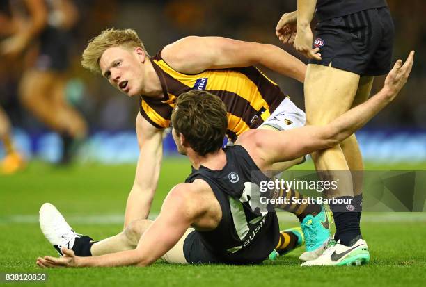 Jed Lamb of the Blues and James Sicily of the Hawks react during the round 22 AFL match between the Carlton Blues and the Hawthorn Hawks at Etihad...