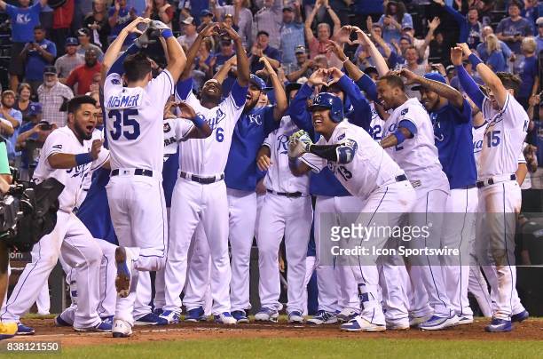 Mob of players greets Kansas City Royals first baseman Eric Hosmer at home plate after he hit a game-winning walk off home run during a Major League...