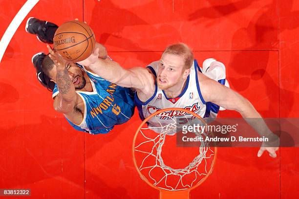 Chris Kaman of the Los Angeles Clippers reaches for the ball against Tyson Chandler of the New Orleans Hornets during their game at Staples Center on...