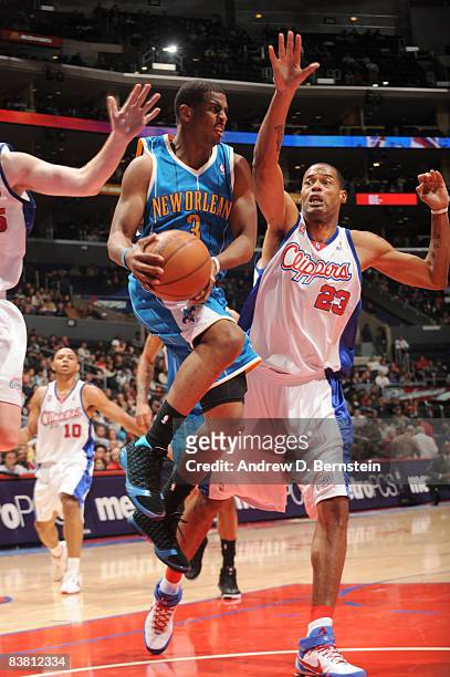 Chris Paul of the New Orleans Hornets handles the ball against Marcus Camby of the Los Angeles Clippers at Staples Center on November 24, 2008 in Los...