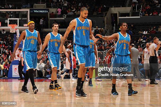 James Posey, Peja Stojakovic, Tyson Chandler, and Chris Paul of the New Orleans Hornets walk off the court following their victory over the Los...