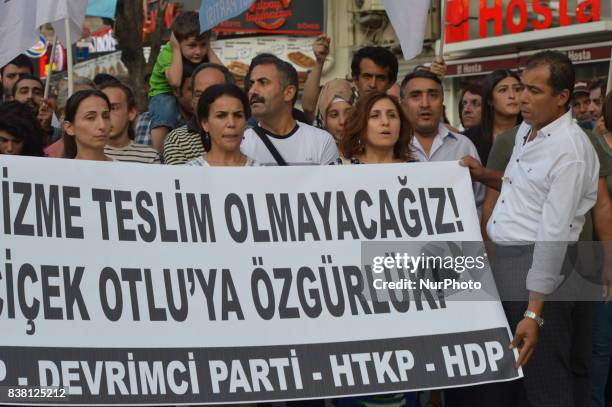 People hold a banner as leftists protest against the Turkish government in Ankara, Turkey on August 23, 2017. The protesters demand that the...