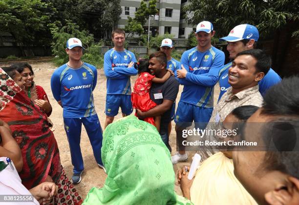 Steve Smith, Jackson Bird, Mitchell Swepson, Josh Hazlewood and Hilton Cartwright of Australia meet families affected by the recent floods during an...