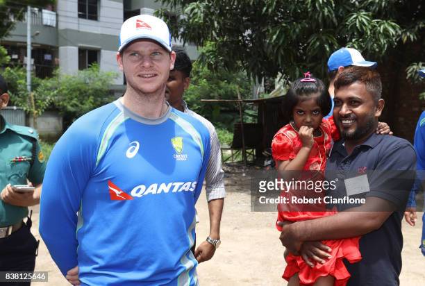 Steve Smith of Australia meets locals affected by recent flooding during an Australian Test Cricket Team media opportunity at Oxfam on August 24,...