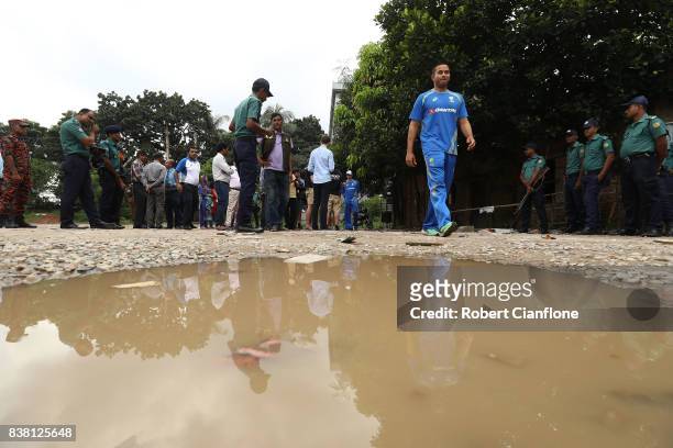 Usman Khawaja of Australia walks by standing water after recent rain during an Australian Test Cricket Team media opportunity at Oxfam on August 24,...