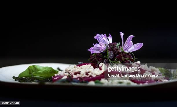 beet carpaccio close up side view - basil leaf on black stock pictures, royalty-free photos & images