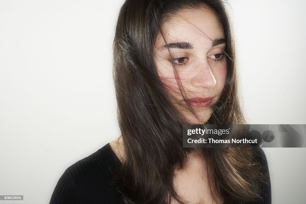 Portrait of young woman, hair blowing