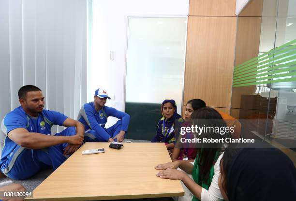 Usman Khawaja and Steve Smith of Australia meet local domestic workers affected by the recent flooding during an Australian Test Cricket Team media...