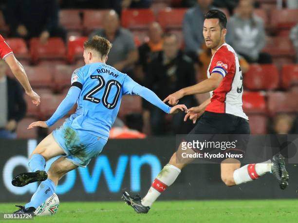 Maya Yoshida of Southampton and Connor Ronan of Wolverhampton Wanderers compete for the ball during the second half of a second-round English League...