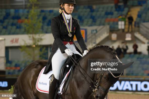 Danish rider Anna Zibrandtsen on Arlando arrives at the price giving ceremony for the team dressage competition at the 2017 FEI European...