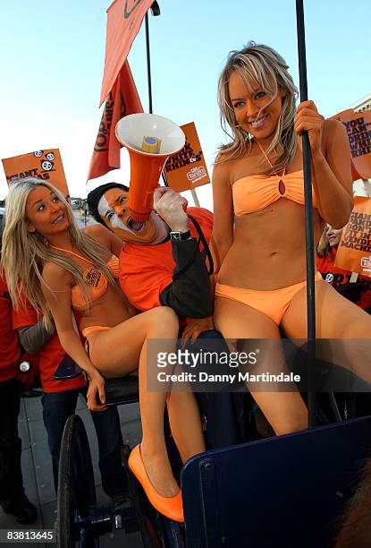 Dom Joly Promotes 'Tango' in a cart pulled by a Shetland pony, flanked by body painted orange page 3 models, and orange "umpa lumpas" by London...