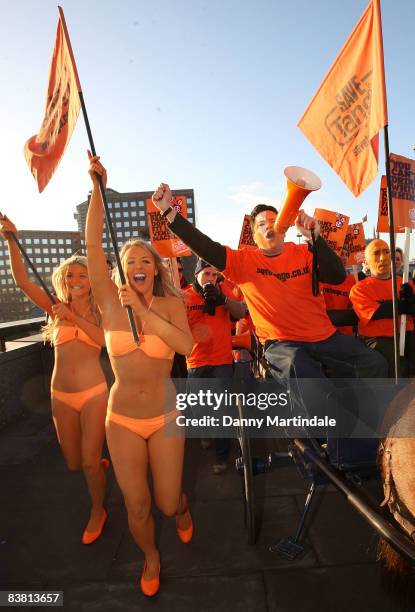 Dom Joly Promotes 'Tango' in a cart pulled by a Shetland pony, flanked by body painted orange page 3 models, and orange "umpa lumpas" by London...