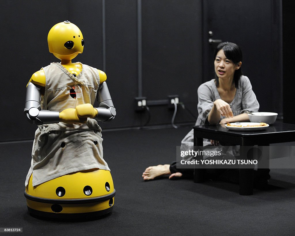 A humanoid robot Wakamaru (L), produced