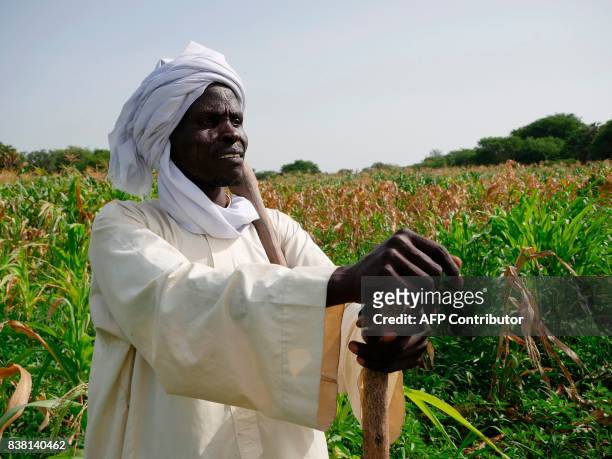 Mal Kalo, farmer and fisherman, poses on Midikouta Island on Lake Chad on July 22 where he returned two years after fleeing an attack of Boko Haram....