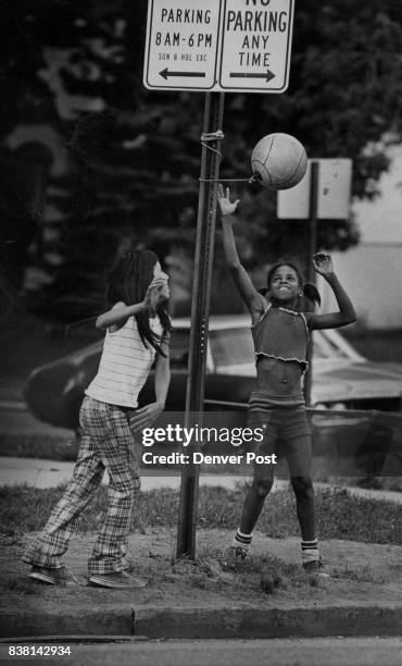 Tether Ball's A Game For Any Location Two Denver girls, Ethel Poorbear, left, and Sherry Brown, enjoyed area's 90degree temperature Thursday with...