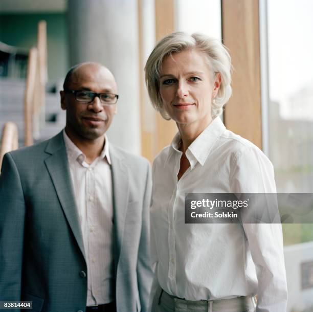 businesswoman and man in office - geheimratsecke stock-fotos und bilder